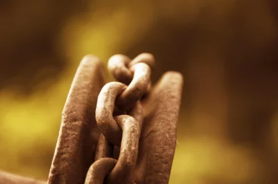 A rusty chain wrapped around a metal spool