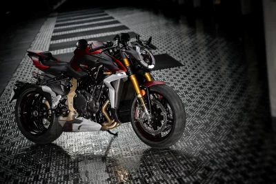 Sleek Red and Black Sport Motorcycle Parked Dramatically on a Patterned Dark Floor image