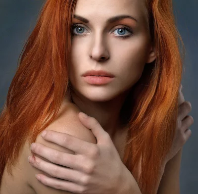 Captivating Portrait of a Red-Haired Woman with Striking Blue Eyes image