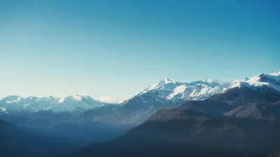 Panoramic Snow-Capped Mountain Range Under Clear Blue Sky image