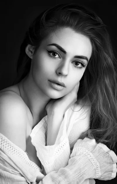 Monochrome Portrait of Woman with Hand on Chin, Serene Gaze image