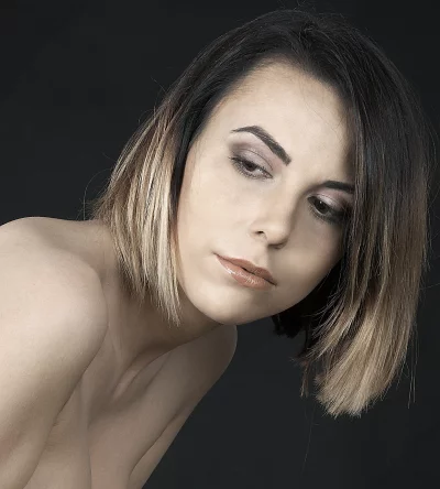 Pensive Young Woman with Stylish Ombre Bob Hair and Bare Shoulders image
