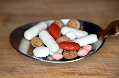 Assorted Medical Pills and Capsules on Silver Spoon for Healthcare image