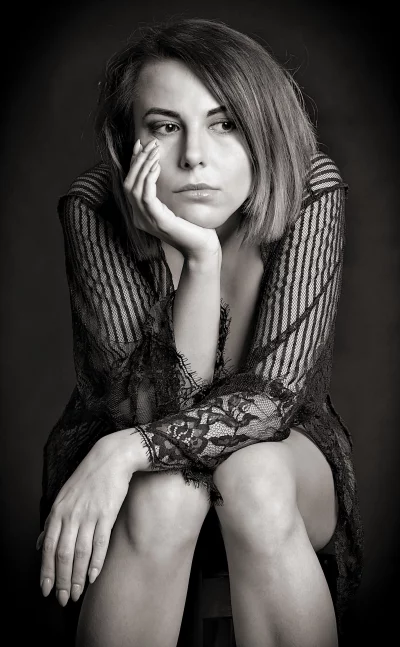 Pensive Woman in Delicate Lace, Striking Black and White Studio Portrait image