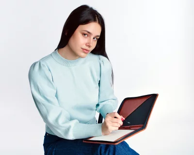 Young Woman Writing Notes in Planner for Work or Study Modern Lifestyle Stock Photo image