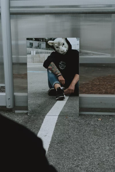 a low angle, looking up at a person wearing a sheep mask
