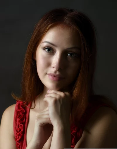 Captivating Redhead Woman with Green Eyes Posing in Red Blouse image