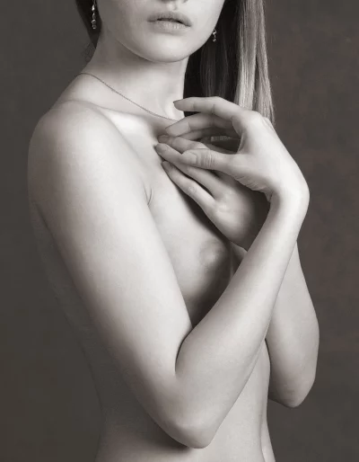Serene Monochrome Portrait of Woman's Bare Torso with Hands Covering Chest image