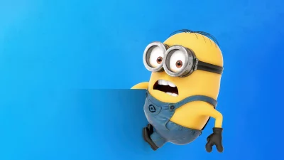 Funny Minion Character Holding Blank Blue Sign Surprised Expression Cinematic Wallpaper image