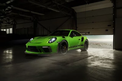 Vibrant Green Porsche 911 GT3 RS Sports Car in Dark Garage with Open Door image