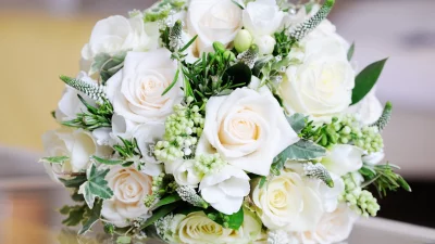 Elegant Bridal Bouquet Featuring Pristine White and Cream Roses with Lush Greenery image