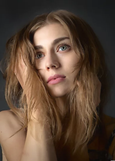 Thoughtful Portrait of a Beautiful Young Woman with Flowing Blonde Hair image