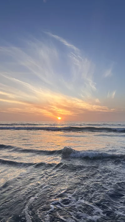Serene Ocean Sunset with Gentle Waves Reflecting Golden Light