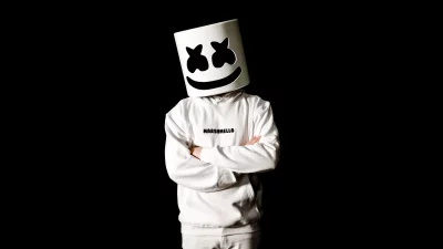 Person Wearing Marshmello DJ Helmet and White Hoodie on Black Background image