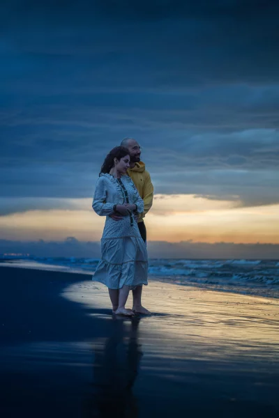 Couple Embracing on Serene Beach at Sunset