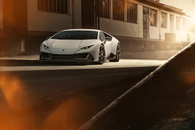 Sleek White Lamborghini Huracan Supercar Parked at Golden Hour Industrial Setting image