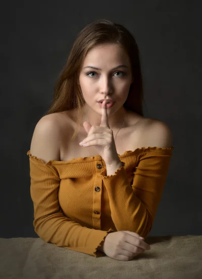 Young Woman Making Silence Gesture with Finger to Lips Portrait image