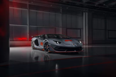 Luxurious Dark Grey Lamborghini Aventador Sports Car with Orange Accents in Modern Garage image