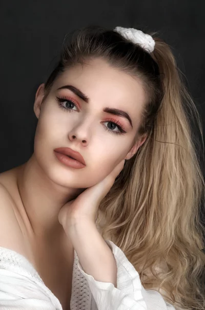 Elegant Woman with Wavy Blonde Hair and Expressive Gaze image