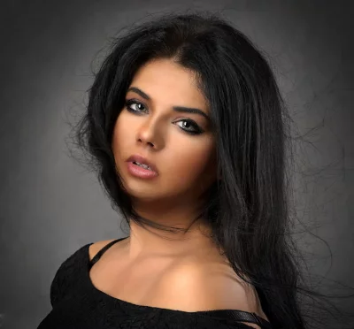 Mesmerizing Close-up Portrait: Young Woman with Dark Hair and Striking Light Eyes image
