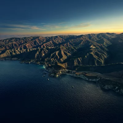 Stunning Aerial View of Coastal Mountains Ocean and Bridge at Golden Sunset image