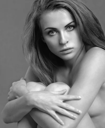 Artistic Black and White Portrait of a Pensive Young Woman Hugging Her Knees image