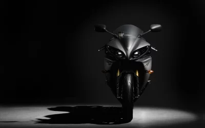 Sleek Matte Black Sport Motorcycle Illuminated on Dark Background Studio Shot image