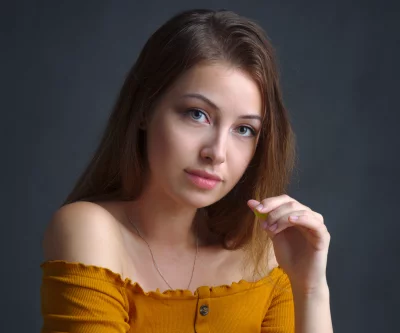 Pensive Young Woman in Yellow Off-Shoulder Ribbed Top Studio Portrait image