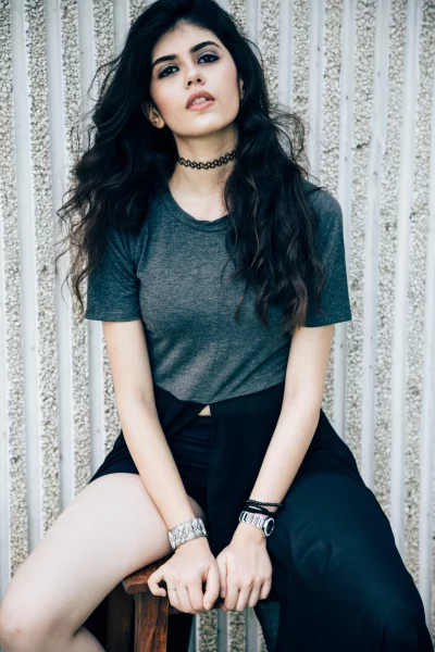 Confident Young Woman Sitting Elegantly Stylish Posing with Long Dark Hair image