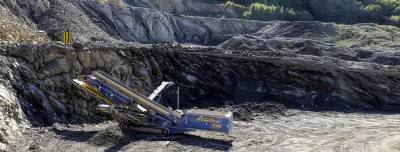 Industrial Rock Crusher Machine Operating in a Deep Quarry image