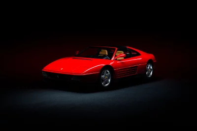 Striking Red Ferrari 348 Classic Sports Car with Tan Interior on Dark Stage image