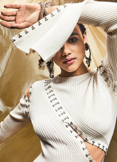 Elegant Woman in Unique Ribbed Sweater with Hook Closures and Ornate Jewelry image