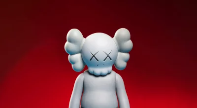 Stylish KAWS Companion Collectible Art Toy on a Vibrant Red Background image