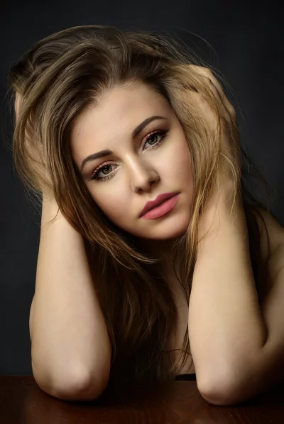 Expressive Woman with Tousled Hair and Striking Green Eyes image