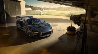 Sleek McLaren Senna Supercar in Hangar with Private Aircraft on Airfield image