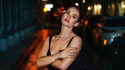 Glamorous Woman Posing with Sparkling Diamond Jewelry in a Vibrant City Night image