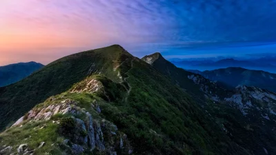 Vibrant Twilight Gradient Over Lush Green Mountain Ridge Pathway image