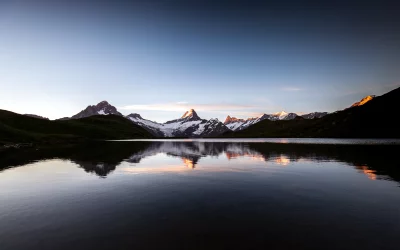 Majestic Alpine Lake Reflecting Snow-Capped Peaks at Golden Hour Dawn image