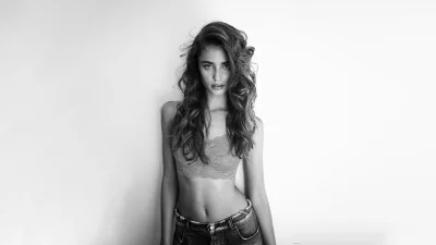 Captivating Black and White Portrait of a Young Woman in Lace Bralette and Jeans image