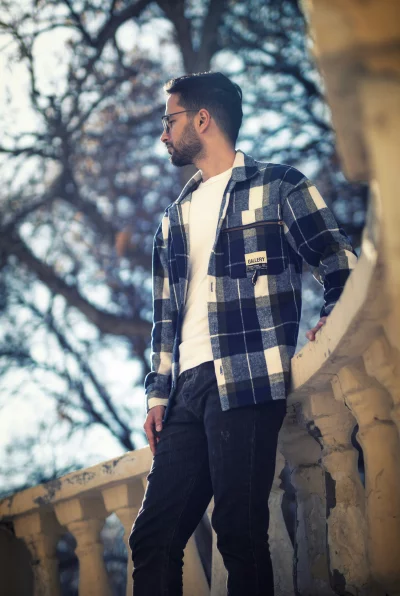 Stylish Young Man in Plaid Shirt Outdoors
