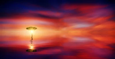 Ethereal Glowing Tree Reflected in Serene Water at Vibrant Sunset image