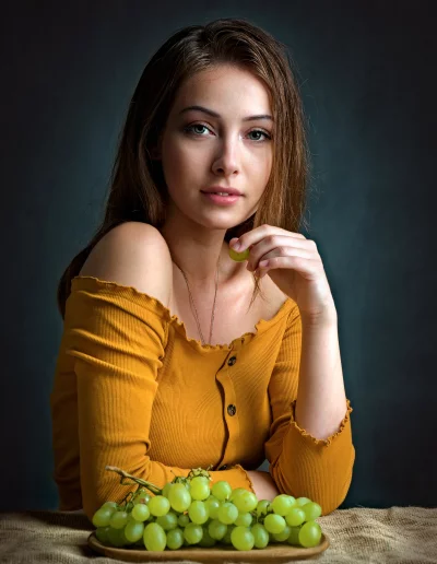 Young Woman Posing with Fresh Green Grapes for Healthy Lifestyle image