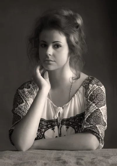 Pensive Young Woman in Traditional Blouse, Sepia Portrait with Thoughtful Gaze image