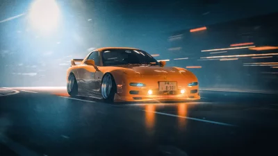 Vibrant Orange Sports Car Speeding Through Dark Urban Night with Glowing Headlights image