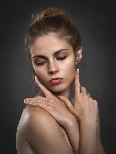 Serene Beauty Portrait: Young Woman with Closed Eyes and Elegant Hand Gesture image