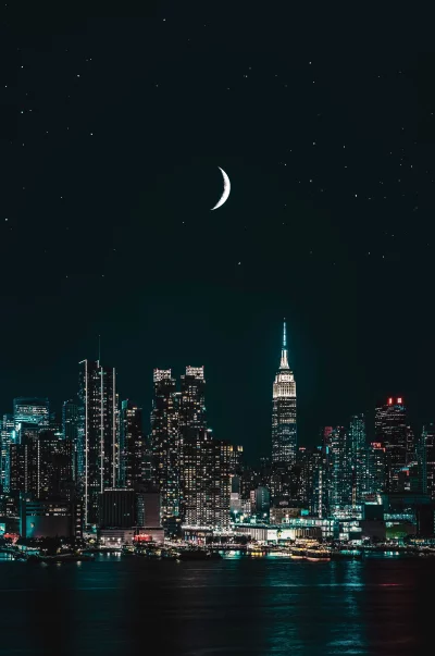 Stunning Night View of New York City Skyline with Empire State Building Under Crescent Moon and Stars image