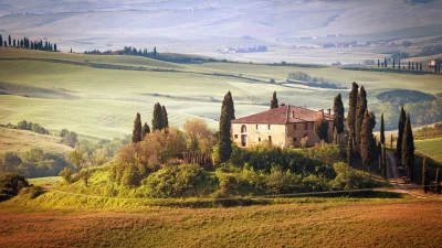 Idyllic Tuscan Villa on Rolling Hills at Golden Hour with Cypress Trees image