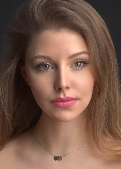 Captivating Young Woman with Emerald Eyes, Flowing Blonde Hair, Pink Lips, Gold Heart Necklace image