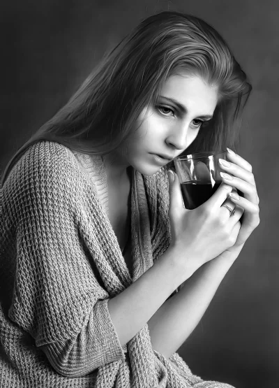 Pensive Young Woman Holding Glass in Black and White Portrait image