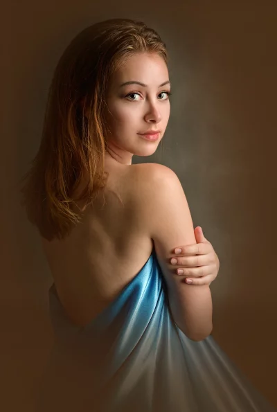 Captivating Young Woman in Blue Drape and Bare Shoulders image